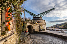 Sightseeing In Würzburg, Germany: Historical Old Crane At The Bank Of The River Main