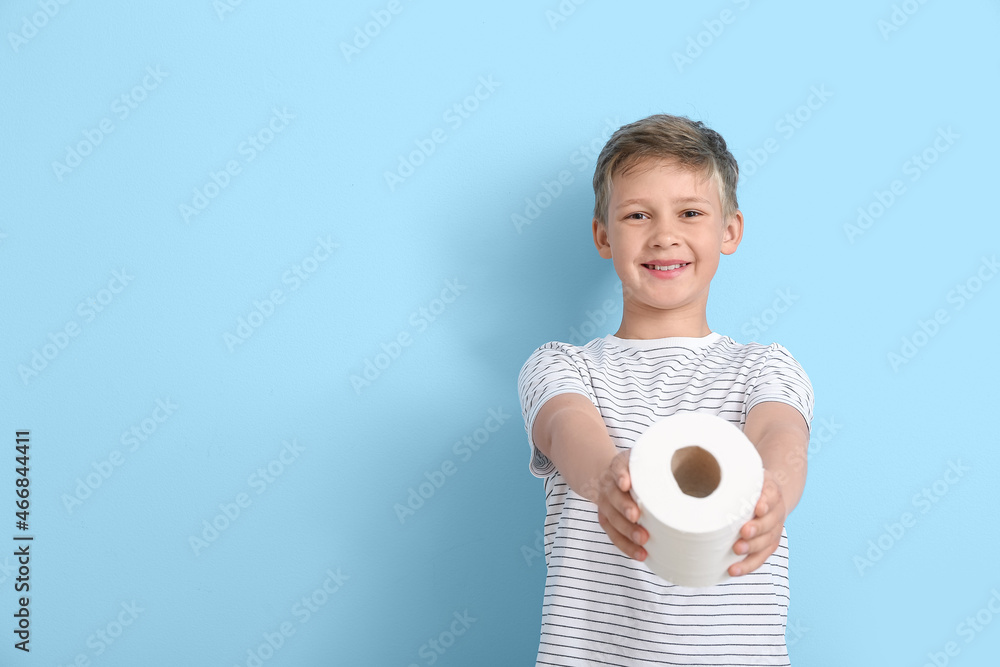 Cute little boy with toilet paper on blue background