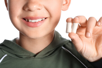 Canvas Print - Little boy with chewing gums on white background, closeup