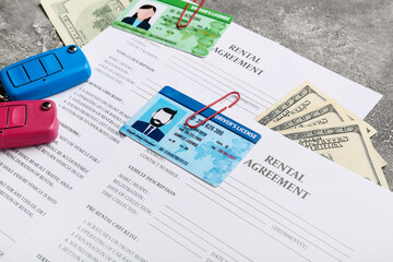 Poster - Rental agreements, driver licenses, money and car keys on grunge background, closeup