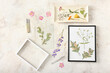 Composition with dried pressed flowers and frames on light background