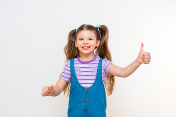 Wall Mural - A little emotional and joyful girl on a white isolated background.