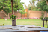 Fototapeta Kuchnia - Thailand Northern traditional modern combination wood table and chair set with wicker plate on it in the garden blur background