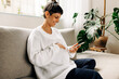 © (JLco) Julia Amaral - Carefree pregnant woman video calling her friends at home