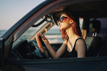 pretty woman in sunglasses driving a car trip