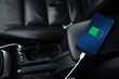 canvas print picture - Mobile phone ,smartphone, cellphone is charged ,charge battery with usb charger in the inside of car. modern black car interior