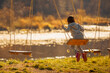 © zwiebackesser - Beautiful young girl having fun on a swing outdoor against on the background of the river and mountains. Copy space.