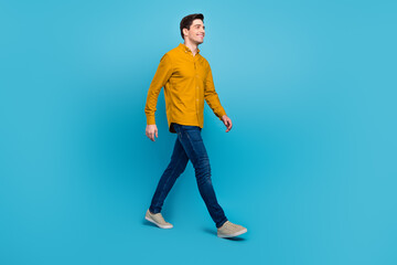 Poster - Profile photo of handsome guy enjoy stroll wear yellow shirt jeans footwear isolated blue color background