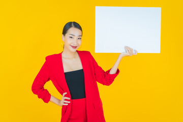 Wall Mural - Portrait beautiful young asian woman with empty white billboard