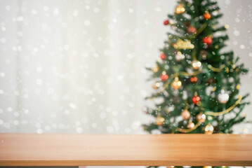 empty christmas table background with christmas tree out of focus for product display montage.