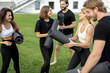 © rh2010 - Group of european people walking with fitness mats on green meadow. Friends practicing yoga and sport exercises. Concept of healthy lifestyle. Athletic men and women barefoot and wear sportswear