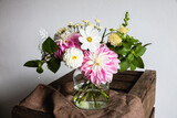 Fototapeta  - Bouquet of summer flowers in a vase on a wooden table