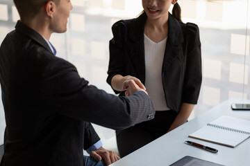 Happy caucasia male and asian female hand shaking, successful businessman handshake after good deal for both companies, business merger and acquisition concept