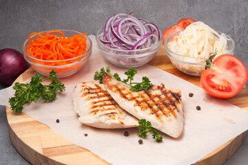 grilled chicken fillet with onions, carrots, cabbage