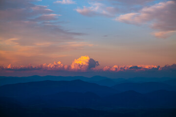 Wall Mural - gorgeous sunset with cloudy sky in the mountains.