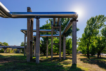 Wall Mural - Steel pipelines outgoing from the plant at sunny day