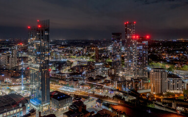 Wall Mural - Deansgate Square and Manchester England, modern tower block skyscrapers dominating the Manchester city centre landscape taken at night,. Aerial view of the city lights