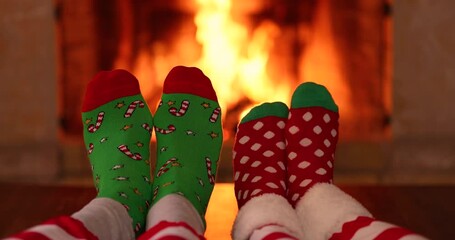 Wall Mural - Couple in Christmas socks near fireplace