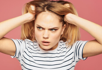 Wall Mural - blonde woman in a striped T-shirt discontent upset studio emotions