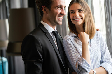 Poster - Young love couple smiling in the comfortable apartment