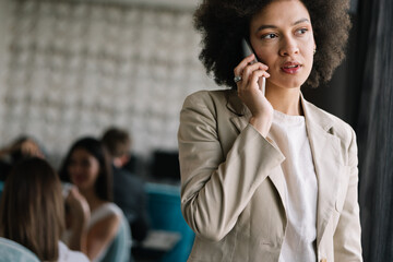 Sticker - Pretty african american business woman talking on her mobile phone