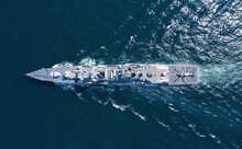 Aerial View Of Naval Ship, Battle Ship, Warship, Military Ship Resilient And Armed With Weapon Systems, Though Armament On Troop Transports. Support Navy Ship. Military Sea Transport.