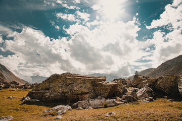 Beautiful view of rocky hills under a sunny cloudy sky in Col de Larche, France