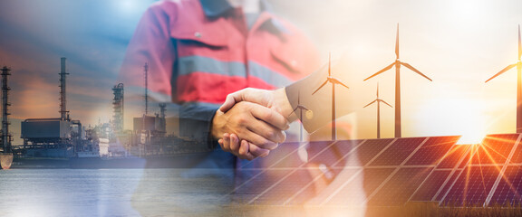 Concept of collaboration to change the world to reduce global warming,energy sources for renewable,sustainability by alternative energy.Double exposure of handshake of wind turbine and night city.