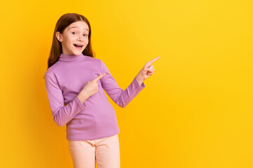 Wall Mural - Photo of happy excited positive good mood little girl point fingers copyspace advertisement isolated on yellow color background