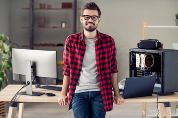 Portrait of attractive successful cheerful guy engineer company owner spending casual day at office work place station indoor
