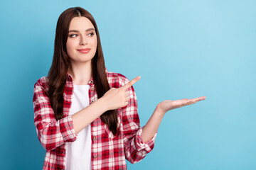 Photo of young girl happy positive smile indicate finger promo offer object discount isolated over blue color background