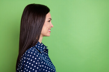 Wall Mural - Profile photo of nice brunette hairdo millennial lady look empty space wear blue blouse isolated on green color background