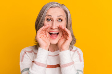 Wall Mural - Photo of adorable sweet retired woman dressed white sweater arms lips making announcement isolated yellow color background