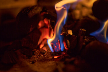 Wall Mural - Closeup shot of burning flames on coals