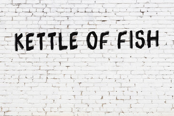 Inscription kettle of fish painted on white brick wall