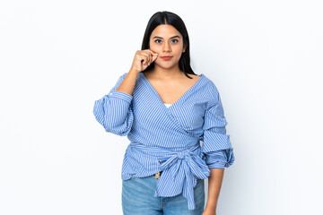 Young latin woman woman isolated on white background showing a sign of silence gesture