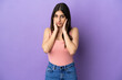 © luismolinero - Young caucasian woman isolated on purple background frustrated and covering ears