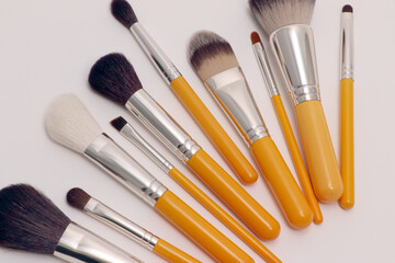 Yellow Makeup brush set on white 