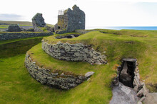 Iron Age Wheelhouse In Front Of Laird's House At The Jarlshof Prehistoric And Norse Settlement In The Shetland Islands, Scotland, Near The North Sea