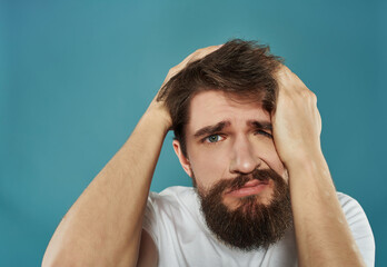 Canvas Print - emotional man in a white t-shirt hand gestures anger Studio