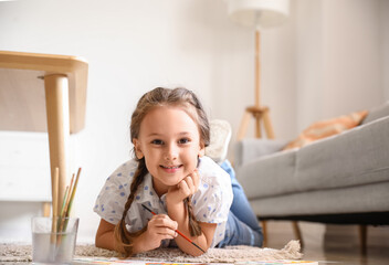 Wall Mural - Little girl painting with watercolor paints on floor at home