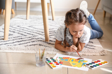 Wall Mural - Little girl painting with watercolor paints on floor at home