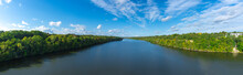 Aerial View Of Mississippi River With Green Trees,  Blue Sky And White Clouds Panorama Minnesota  USA 