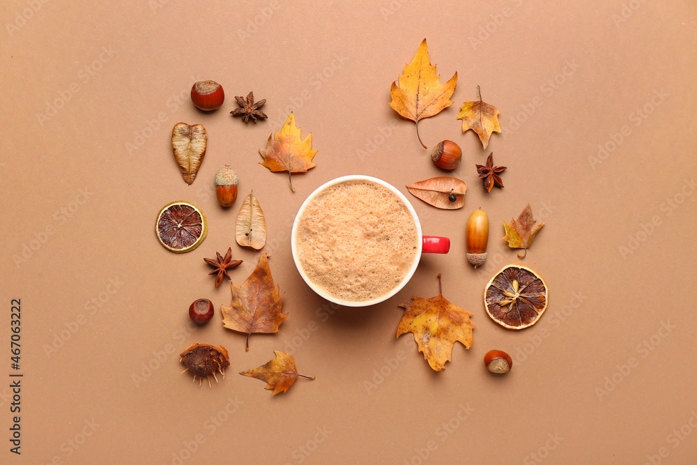 Autumn composition with cup of coffee on color background