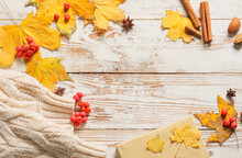 Frame Made With Yellow Autumn Leaves, Rowan Berries And Spices On Light Wooden Background, Closeup