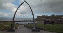 Whitby Showing The Whale Bone Arch And Whitby Abbey In The Background Cloudy Overcast Day UK England.