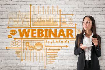 Sticker - Portrait of attractive young european businesswoman with coffee cup and creative webinar sketch on white brick wall background. Knowledge, education and e-learning concept.