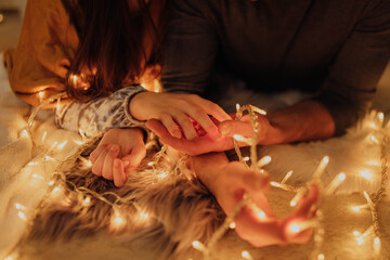 Sticker - Christmas lights in the hands of a beautiful couple