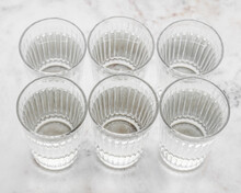 Overhead View Of Six Glasses Of Water On A Table