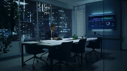 Leinwandbilder - Successful Handsome Businessman Working on Laptop Computer in Big City Office Late in the Evening. Finance Investment Analyst Checking Line and Pie Graphs from Project Management Report.